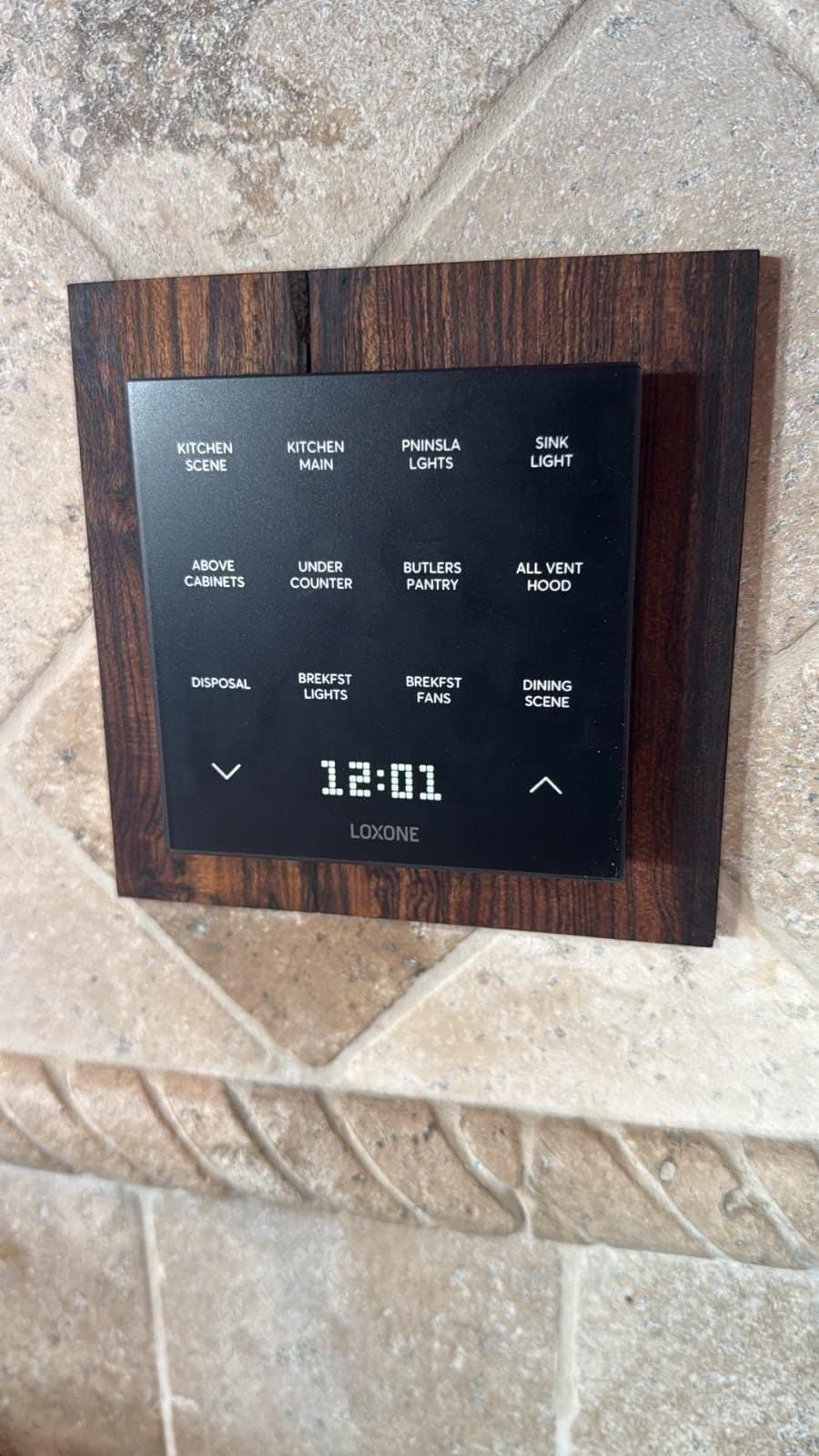 LOXONE Touch Pure Flex keypad installed in a Houston home replacing a legacy lighting controller — flush glass surface with backlit scenes